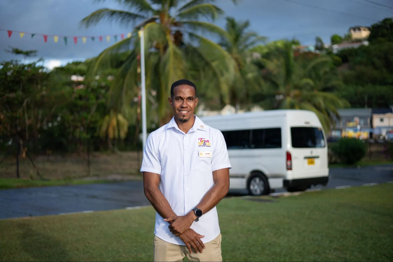 Garth Woodroffe, owner and guide of Tour De Spice, standing in front of a Tour De Spice van in Grenada